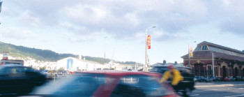 Cars driving past on a road.