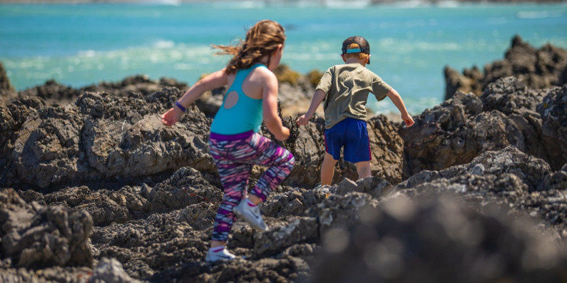 Two kids running on rocks, Wellington