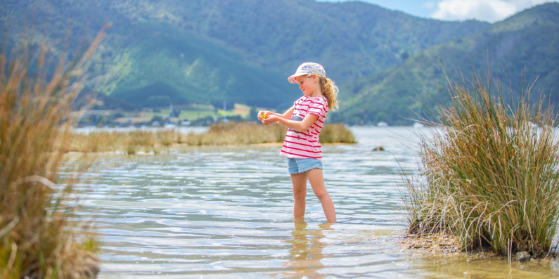 Girl standing in water at Queen Charlote Sounds, Marlborough