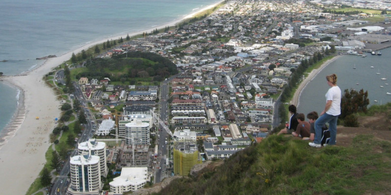 People sitting on top of Mt Manganui overlooking the Mout