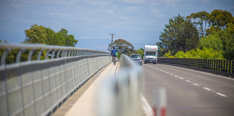 Bridge with a cyclist and cars on it