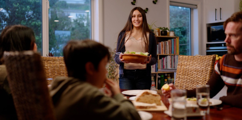 Image of a family at their house about to have dinner