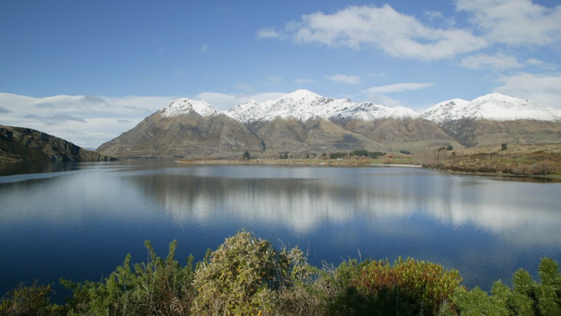 Snow capped mountains with a lake in the foreground