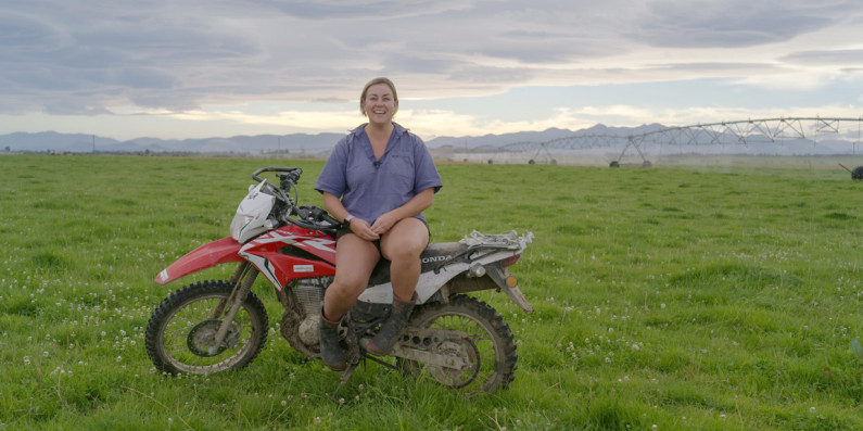 Ash-leigh, a Dairy Farmer sitting on her motorbike.