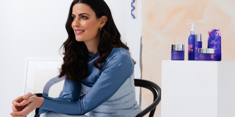 Emma Lewisham sitting in front of her beauty products.