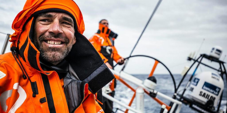 Stu Bannatyne and a fellow team member on a racing boat.
