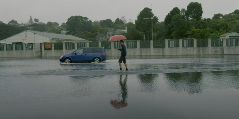 A person walking through water during a flood.
