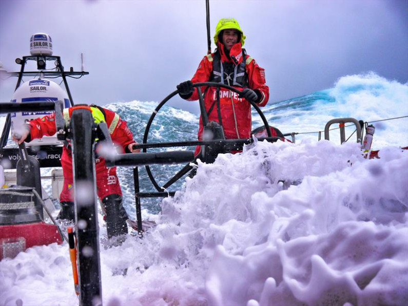 Stu Bannatyne and a team member on a boat within choppy waters as part of an ocean race.