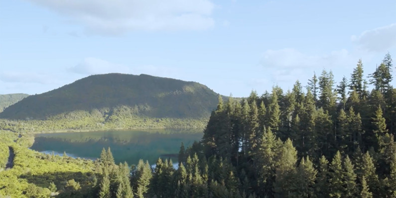 A lake surrounded by forests and hills.