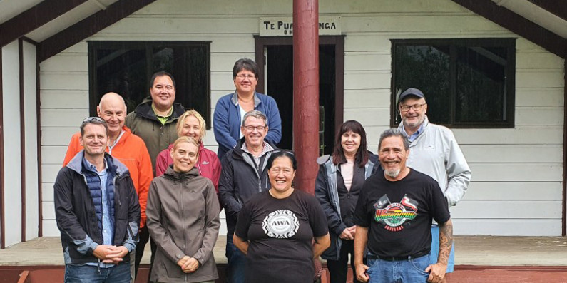 A group of people standing in front of Teke Kinga Marae.