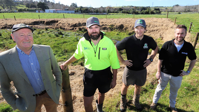 Four men standing in front of a Maunu property.